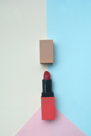 Red lipstick isolated on pastel background, Minimal makeup fashion concept.の写真素材