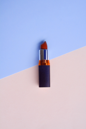 Red lipstick isolated on pastel background, Minimal makeup fashion concept.の写真素材