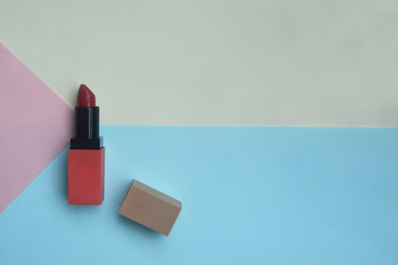 Red lipstick isolated on pastel background, Minimal makeup fashion concept.の写真素材