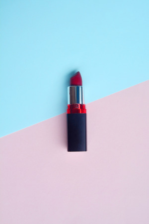 Red lipstick isolated on pastel background, Minimal makeup fashion concept.の写真素材