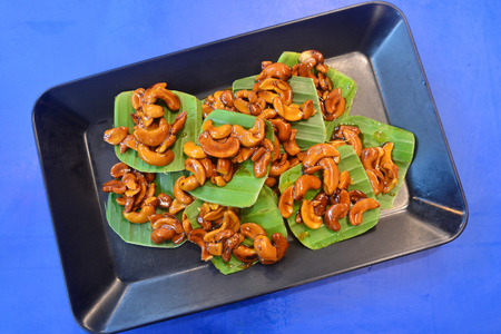 Caramel cashew nuts on banana leaves, Thai southern thailand traditional snack.の写真素材