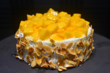 Cheesecake with mango fruit on a luxury all you can eat buffet in a hotel, assorted sweet flour dessert, cakes, in a cafe, bar, hotel restaurant or hotel.の写真素材