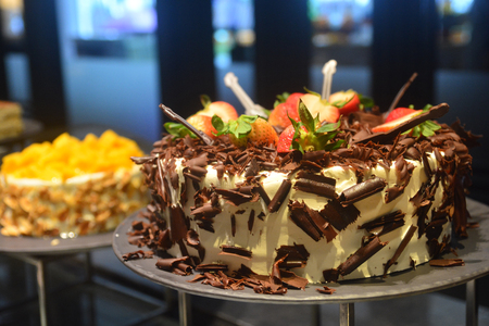 Chocolate and fruit cake on a luxury all you can eat buffet in a hotel, assorted sweet flour dessert, cakes, in a cafe, bar, hotel restaurant or hotel.の写真素材