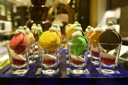 Colorful Macarons sweets and desserts served at pastry station on the buffet.の写真素材