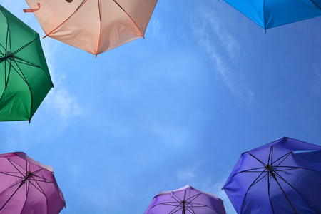 Vibrant colorful opened umbrellas background. Colorful umbrellas in the sky for wallpaper, summerの写真素材