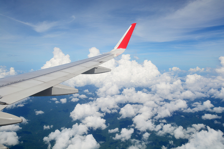 Aerial view Clouds and sky as seen through window of an aircraftの写真素材