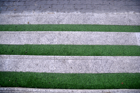 Green grass stair step,Top view green grass step stairs for interior background.Green artificial grass on stair/step, background and texturesの写真素材