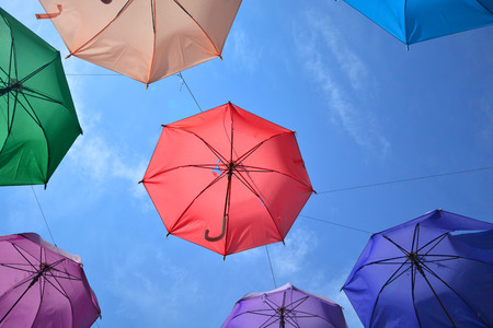 Vibrant colorful opened umbrellas background. Colorful umbrellas in the sky for wallpaper, summerの写真素材