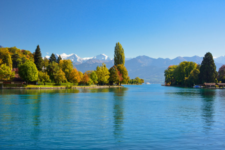 Lake Thun with Jungfrau mountain in autumn on clear blue sky , Switzerland, Shot using CPL  filterの写真素材