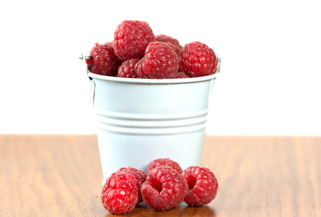 Fresh organic raspberry in white basket. Selective focusの写真素材