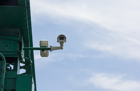 Colour picture of surveillance cameras on blue backgroundの写真素材