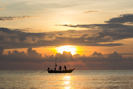 Fishermans silhouette in the sea at sunset.の写真素材