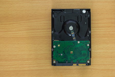 Computer hard drive on wooden backgroundの写真素材