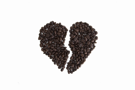 broken heart from coffee beans isolated on a white backgroundの写真素材