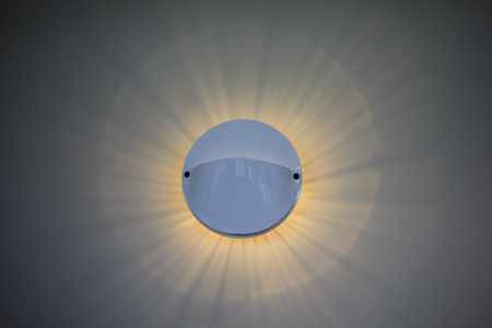 circle wall lamp and ray light on white backgroundの写真素材