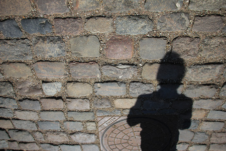 Shadows of people in a street of the cityの写真素材