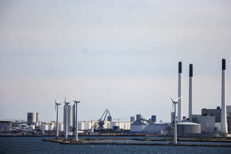white wind turbine generating electricity on seaの写真素材