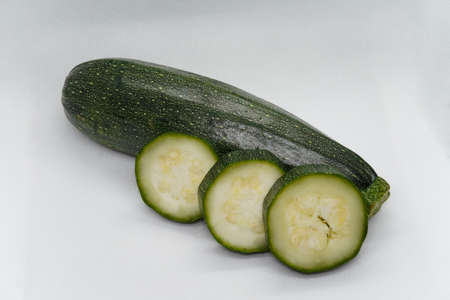 courgette, zucchini, baby marrow, cucumber, in white grid backgroundの写真素材