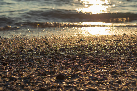 Picture of small stones lined up on the beach by the sea in the evening.の写真素材