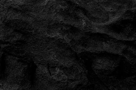 Mysterious black stone floor or maybe a cave wall in the dark can be used as wallpaper, suitable for work related to geology or nature and minerals, or to be used in architecture and home related workの写真素材