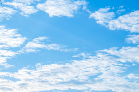 A view of the bright sky on a holiday afternoon with many white clouds lined up. It can be used as a...