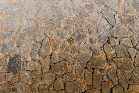 A walkway of several stones arranged in layers, or perhaps a wall with many cracks, can be used as a wallpaper for architecture and design projects, or for geological work.の写真素材