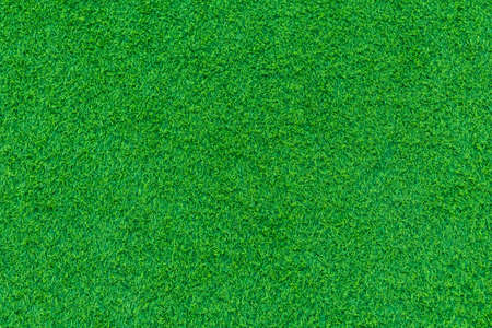 The green artificial grass in the football field is taken from above, or it can be artificial grass in the garden, can be used as a background. Suitable for sports or home and garden work.の写真素材