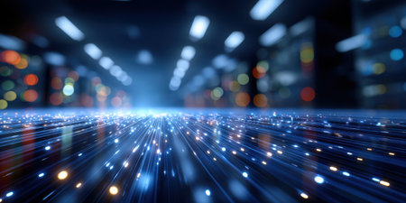 Digital data streams glowing with blue light in futuristic technology environment with bokeh lightsの素材