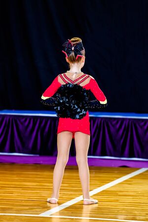cheer girl with pompons view from the backの写真素材