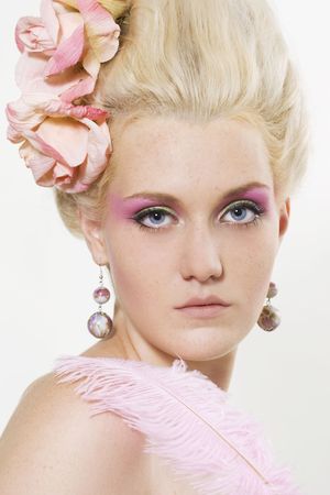 Portrait of beautiful young woman with stylish make-up and medieval hairstyle with rosesの写真素材