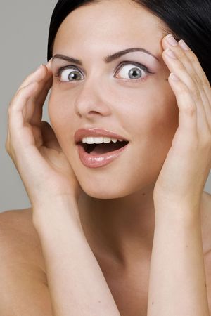 Closeup portrait of surprised young beautiful womanの写真素材