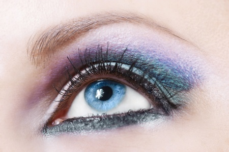 Macro shot of woman eye with violet and blue bright make-up の写真素材