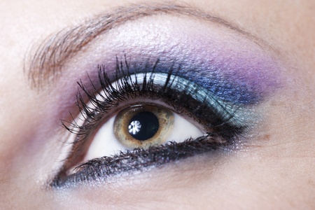 Macro shot of woman eye with violet and blue bright make-up の写真素材