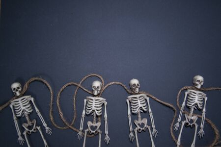 Human skeletons on rope on darkの写真素材
