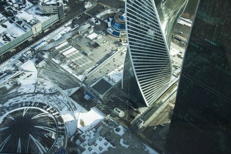 Top view of a big city in winter. Winter panorama of the city landscape. A group of roof buildings covered by snow.の写真素材