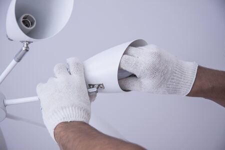 Repair of premises. Electrical work indoors. Workers hands in white gloves.の写真素材