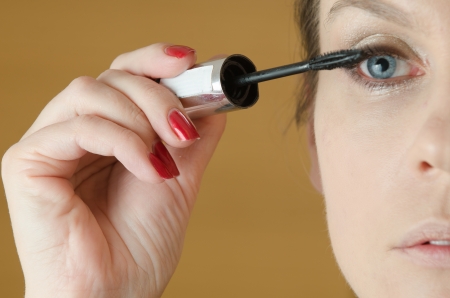 Close-up of young woman in make - up processの写真素材