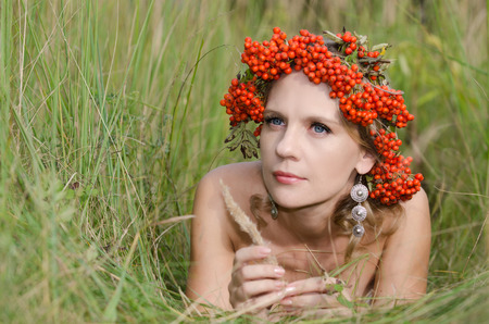 Young woman with rowan (sorbus, mountain ash)の写真素材