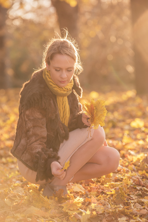 Portrait of beautiful woman in autumn parkの写真素材