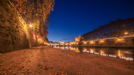 Autumn leaves on the embankment of Tiber River in Rome, Italy. Vatican city in the backgroundの写真素材