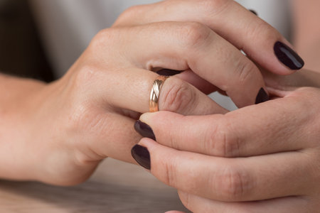 Divorce, separation: hands of woman removing wedding or engagement ringの写真素材