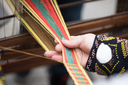 Hands of woman weaving traditional Lithuanian ethnic band from linenの写真素材