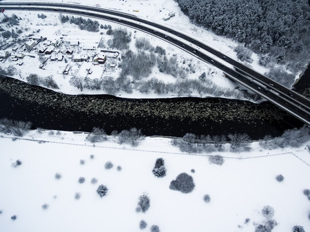 Vilnius, Lithuania: aerial top view of Neris river, surrounding forests and Gariunai road in winterの写真素材