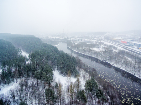 It is snowing in Vilnius, Lithuania, aerial top view of Neris river in winterの写真素材