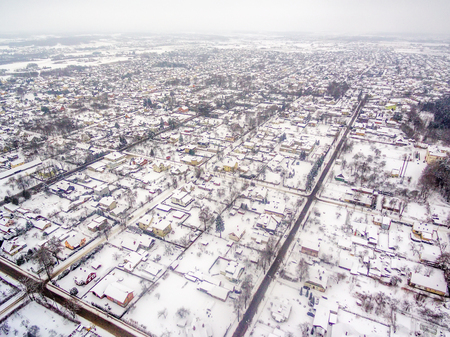 Aerial top view of snowy detached houses in winterの写真素材