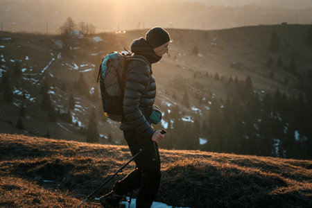 Hiker Walking at Sunrise in the Mountainsの写真素材