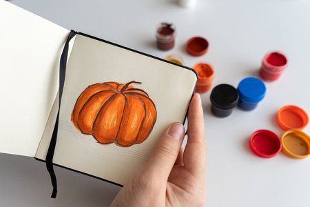 Artist Mixing Orange Gouache for Pumpkin Paintingの写真素材