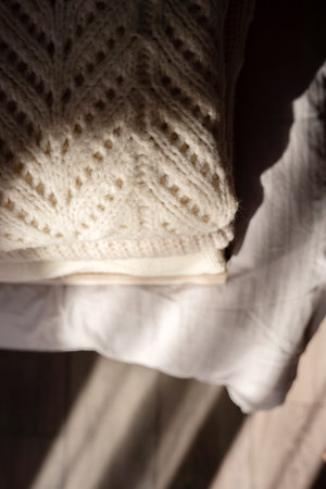 Stack of Cozy Knit Sweaters in Natural Lightの写真素材
