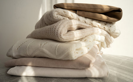 Stack of Cozy Knit Sweaters in Natural Lightの写真素材