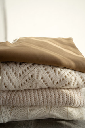 Stack of Cozy Knit Sweaters in Natural Lightの写真素材